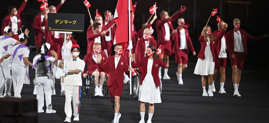 Daniel Wagner og Lisa Kjær Gjessing fører den danske delegation ind på det olympiske stadion i Tokyo. Foto: Lars Møller